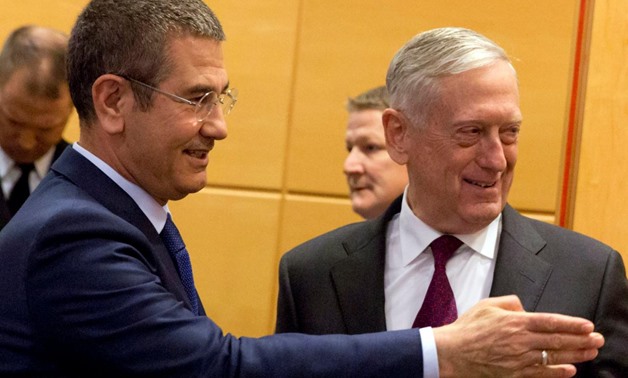U.S. Secretary of Defence Jim Mattis poses with Turkish Defence Minister Nurettin Canikli during a NATO defence ministers meeting at the Alliance headquarters in Brussels, Belgium, February 14, 2018. REUTERS/Virginia Mayo/Pool