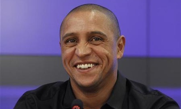 Anzhi Makhachkala team director Roberto Carlos laughs during a news conference in Moscow March 29, 2012. REUTERS/Sergei Karpukhin