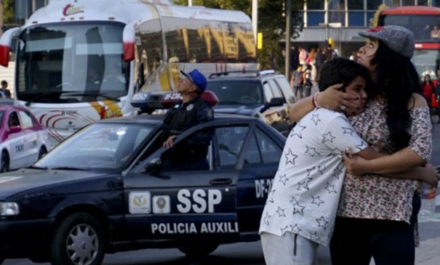 A woman embraces a boy as a powerful earthquake rocks Mexico City on February 16, 2018 - Yuri Cortez, AFP 