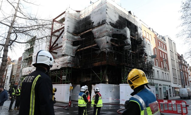 Firefighters look at the damaged caused by a fire at a construction site in central London, Britain, February 17, 2018. REUTERS/Simon Dawson
