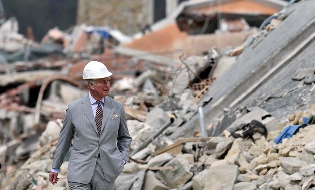 Britain's Prince Charles walks during his visit to the town of Amatrice, which was levelled after an earthquake last year, in central Italy April 2, 2017. REUTERS/Emiliano Grillotti