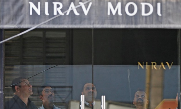 Security guards stand inside a Nirav Modi showroom during a raid by the Enforcement Directorate, a government agency that fights financial crime, in New Delhi, India, February 15, 2018. REUTERS/Adnan Abidi
