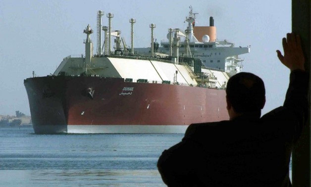 FILE- : FILE PHOTO - A man looks as the world's biggest Liquefied Natural Gas (LNG) tanker, Qatari-flagged DUHAIL as she crosses through the Suez Canal April 1, 2008. REUTERS/Stringer/File Photo