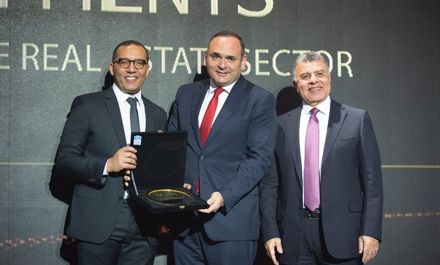 HPD Chief Executive Officer Amin Serag receives the Crystal Award during the ceremony organized by BT magazine - Egypt Today