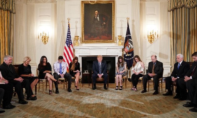 US President Donald Trump (C), who met with survivors of a mass shooting at a Florida high school, is pushing the idea of arming teachers to keep schools safe - AFP
