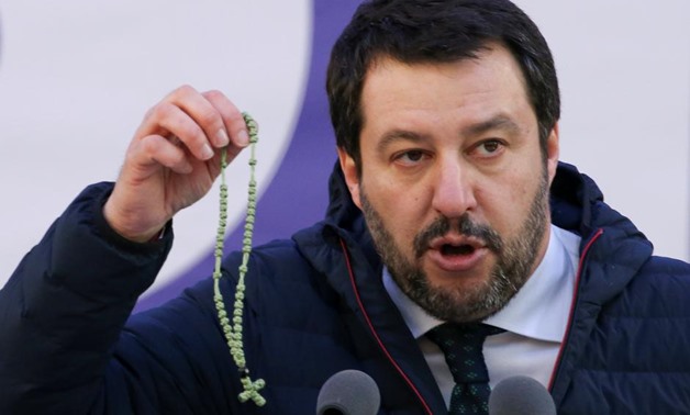 Italian Northern League leader Matteo Salvini shows a rosary as he speaks during a political rally in Milan, Italy February 24, 2018. REUTERS/Tony Gentile

