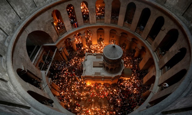 Worshippers hold candles as they take part in the Christian Orthodox Holy Fire ceremony at the Church of the Holy Sepulchre in Jerusalem's Old City April 15, 2017. REUTERS/Ammar Awad/File Photo
