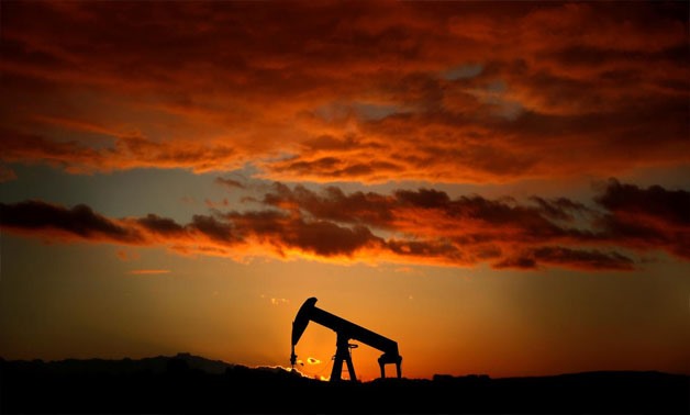 An oil pump jack is seen at sunset in a field outside Scheibenhard, near Strasbourg, France, October 6, 2017. REUTERS/Christian Hartmann/File Photo