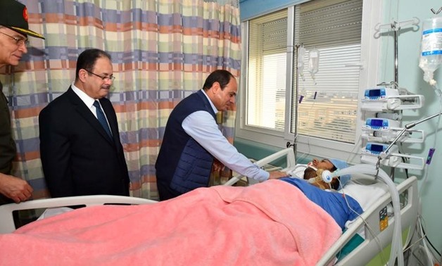 Egyptian President Abdel Fattah al-Sisi (3rd L) visits police officer Mohamed El-Hayes who was rescued after being kidnapped during an attack in the Western Desert, at a military hospital in Cairo, Egypt, November 1, 2017 in this handout picture courtesy 