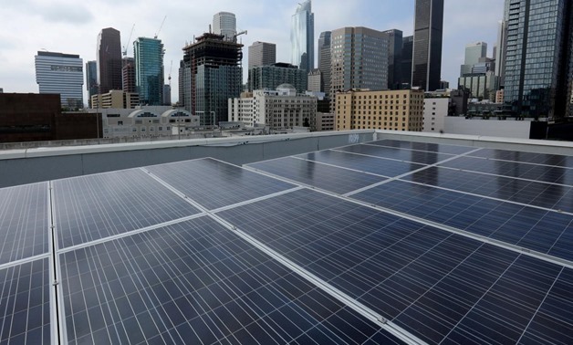 Solar electric panels are shown installed on the roof of the Hanover Olympic building, the first building to offer individual solar-powered net-zero apartments in Los Angeles, California, U.S., June 6, 2017 - REUTERS/Mike Blake/File Photo