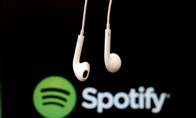 FILE PHOTO: Headphones are seen in front of a logo of online music streaming service Spotify in this February 18, 2014 illustration picture. REUTERS/Christian Hartmann/File Photo
