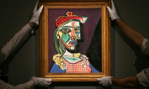 A Pablo Picasso portrait of his muse Marie-Therese Walter with future lover Dora Maar emerging from the shadows fetched £50 million (57 million euros, $69 million) at a London sale Wednesday, a European auction record for a painting