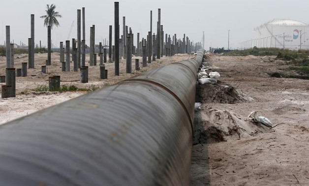 An oil pipeline is laid next to the Vopak-Dialog oil storage facility (R) and a Refinery and Petrochemical Integrated Development (RAPID) project construction site in Pangerang in Malaysia's southern state of Johor October 6, 2015. REUTERS/Edgar Su/File P