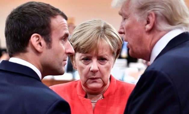 FILE PHOTO - French President Emmanuel Macron, German Chancellor Angela Merkel and U.S. President Donald Trump confer at the start of the first working session of the G20 meeting in Hamburg, Germany, July 7, 2017. REUTERS/John MacDougall/Pool