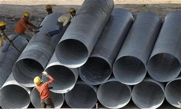 Labourers work on steel pipes at a construction site of an overhead flyover in Chennai January 21, 2010 -
 REUTERS/Babu/Files
