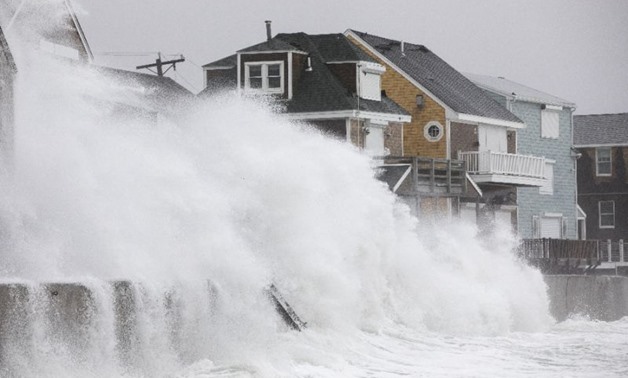 Waves crash over houses in Massachusetts as a major winter storm strikes the US east coast - AFP 
