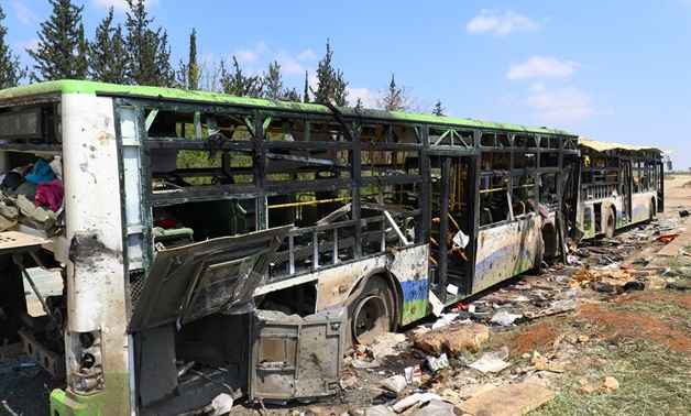 Damaged buses are seen after an explosion  al-Rashideen village - AFP