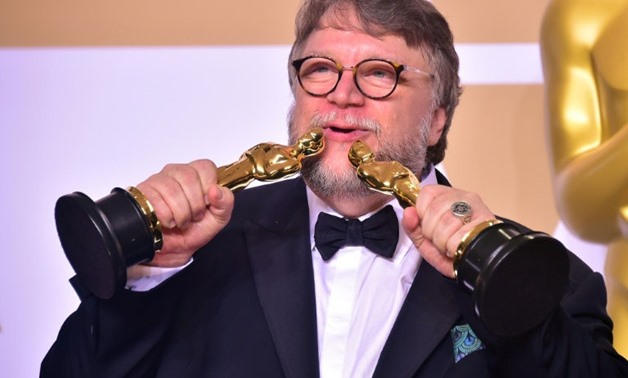 Guillermo del Toro poses with his two Oscars -- for best picture and best director for "The Shape of Water"
