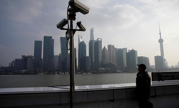 A man stands on the Bund in front of Shanghai's financial district of Pudong in Shanghai, China February 26, 2018. REUTERS/Aly Song