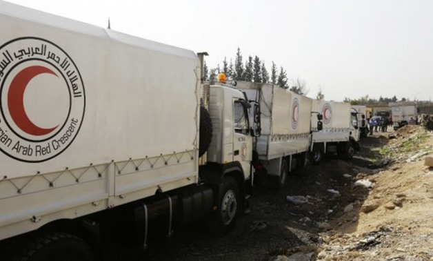 Louai Beshara, AFP | Syrian Arab Red Crescent vehicles at the al-Wafideen checkpoint before delivering aid to Eastern Ghouta on March 5, 2018.
