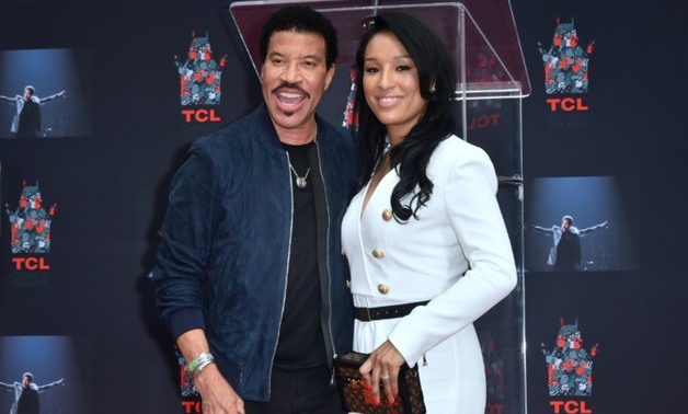 Lionel Ritchie and girlfriend Lisa Parisi at his Hand and Footprints ceremony at the TCL Theater in Hollywood, California; the 68-year-old R&B singer has sold more than 100 million records over a career spanning six decades