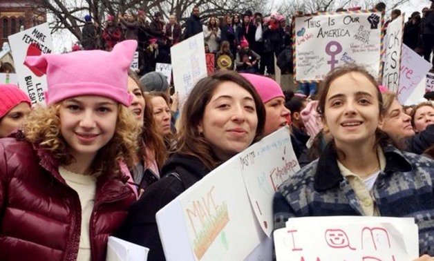 Naomi Wolf's daughter, Rosa, centre, and two friends join protesters in Washington - Reuters
