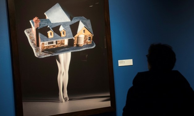 A guest looks at "Walking House," by artist Laurie Simmons, at the exhibition "Women House" at the National Museum of Women in the Arts in Washington