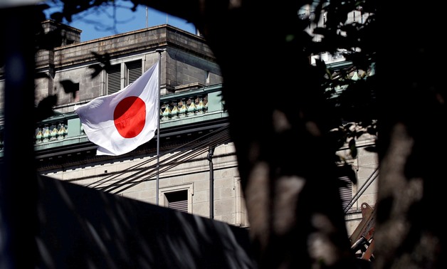A Japanese flag flutters atop the Bank of Japan building under construction in Tokyo, Japan, September 21, 2017. REUTERS/Toru Hanai/File Photo
