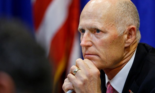 FILE PHOTO - Florida Governor Rick Scott listens during a meeting with law enforcement, mental health, and education officials about how to prevent future tragedies in the wake of last week's mass shooting at Marjory Stoneman Douglas High School, at the C