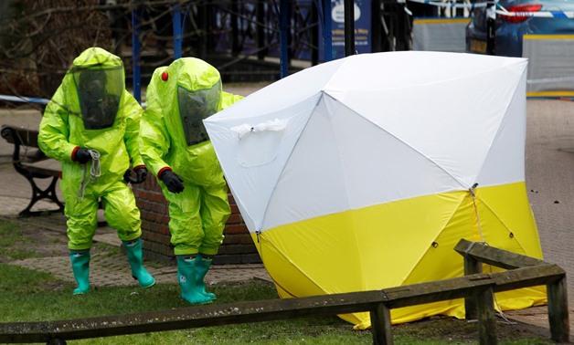 The forensic tent, covering the bench where Sergei Skripal and his daughter Yulia were found, is repositioned by officials in protective suits in the center of Salisbury, Britain. REUTERS/Peter Nicholls