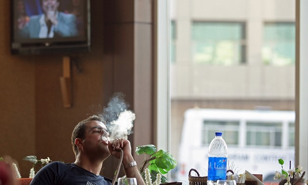 FILE: A young man smoking Shisha in a cafe