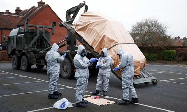 Soldiers wearing protective clothing remove a police vehicle from a car park in Salisbury, Britain, March 11, 2018 - REUTERS/Henry Nicholls. “
