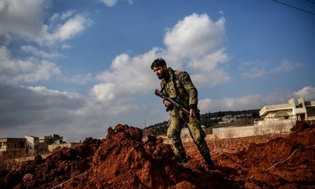 Turkish-backed Syrian rebel fighter stands guard recently on road leading to Afrin – AFP