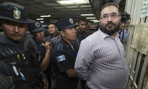 Police search Mexico's former Veracruz state governor Javier Duarte before returning him to his jail cell - Reuters

