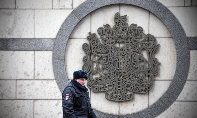 A police officer patrols outside the British embassy in Moscow - AFP
