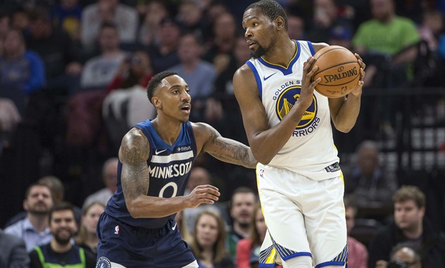 Mar 11, 2018; Minneapolis, MN, USA; Golden State Warriors forward Kevin Durant (35) looks to pass the ball over Minnesota Timberwolves guard Jeff Teague (0) in the second half at Target Center. Mandatory Credit: Jesse Johnson-USA TODAY Sports