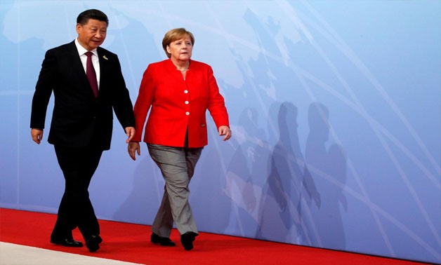  Chinese President Xi Jinping walks next to German Chancellor Angela Merkel to attend the G20 leaders summit in Hamburg, Germany July 7, 2017 -
 REUTERS/Wolfgang Rattay/File Photo