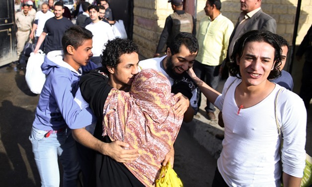 An Egyptian woman hugs a youth who was released from Cairo's Tora prison on November 18, 2016 – AFP