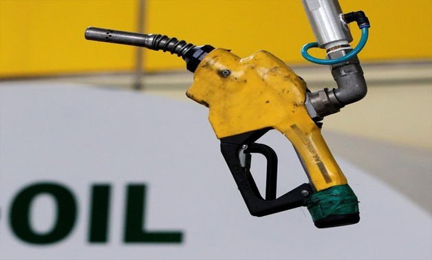 A gas pump is seen hanging from the ceiling at a petrol station in Seoul June 27, 2011. REUTERS/Jo Yong-Hak/File Photo
