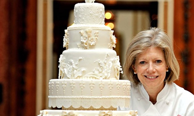 p3 ROYAL WEDDING OF PRINCE WILLIAM OF WALES TO CATHERINE MIDDLETON (KATE MIDDLETON) ON 29TH APRIL 2011. Fiona Cairns stands proudly next to the Royal Wedding cake that she and her team made for Prince William and Kate Middleton, in the Picture Gallery of 
