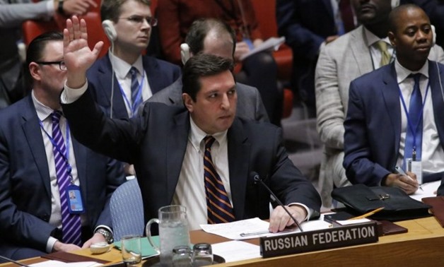 Russian Deputy Permanent Representative to the United Nations Vladimir Safronkov holds up his hand as he votes against a draft resolution that condemned the reported use of chemical weapons in Syria during a meeting at the UN Headquarters in New York, Apr