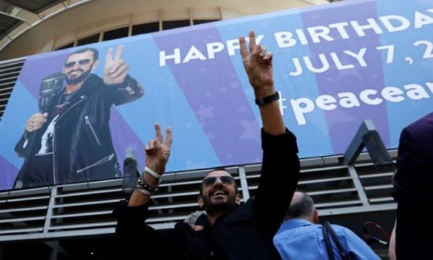FILE PHOTO - Musician Ringo Starr gestures at fans at a "Peace & Love" event to celebrate Starr's 77th birthday in Los Angeles, California, U.S., July 7, 2017. REUTERS/Mario Anzuoni