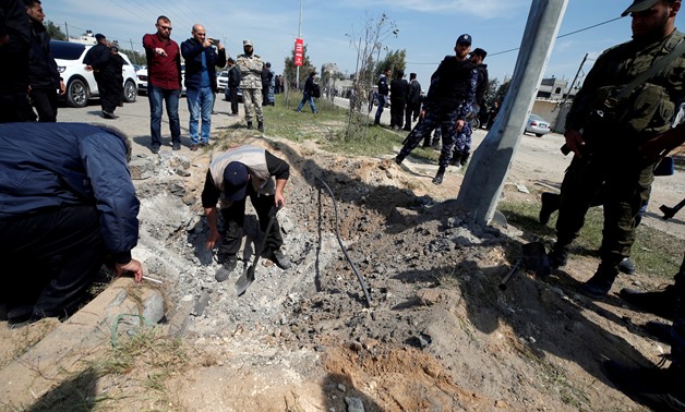 FILE PHOTO: Palestinians inspect the site of an explosion that targeted a convoy that was carrying Palestinian Prime Minister Rami Hamdallah, in the northern Gaza Strip March 13, 2018. REUTERS/Mohammed Salem/File Photo
