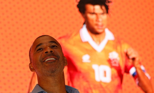FILE PHOTO: Former Dutch national soccer team captain Ruud Gullit smiles in front of a screen projecting an image of him during a World Cup promotional event at a shopping mall in Hong Kong June 8, 2014. REUTERS/Bobby Yip (CHINA - Tags: SPORT SOCCER WORLD