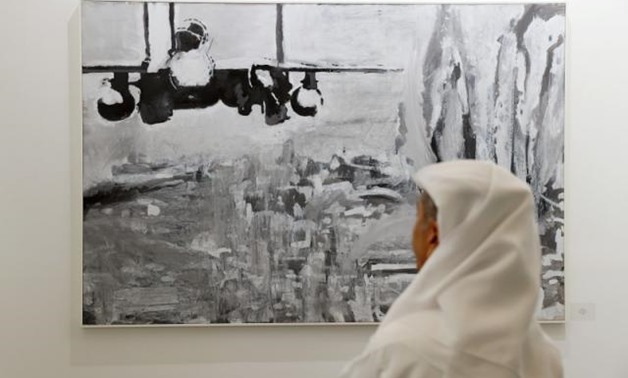A visitor looks at artworks made by a Palestinian artist at the annual Art Dubai exhibition in Dubai, United Arab Emirates March 21, 2018. REUTERS/Ahmed Jadallah