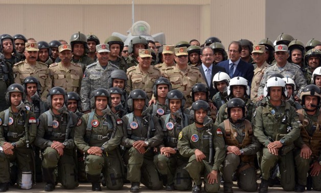 Egypt's President El-Sisi (C) with Egyptian air forces pilots at a North Sinai military air base. Minister of Interior Magdy Abdel-Ghaffar (L) and Minister of Defense Sedki Sobhi (R) 