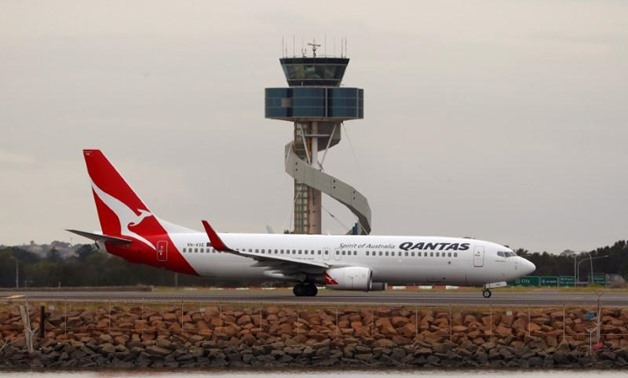 FILE PHOTO: A Qantas plane taxis at Kingsford Smith International Airport in Sydney, Australia, February 22, 2018. REUTERS/Daniel Munoz