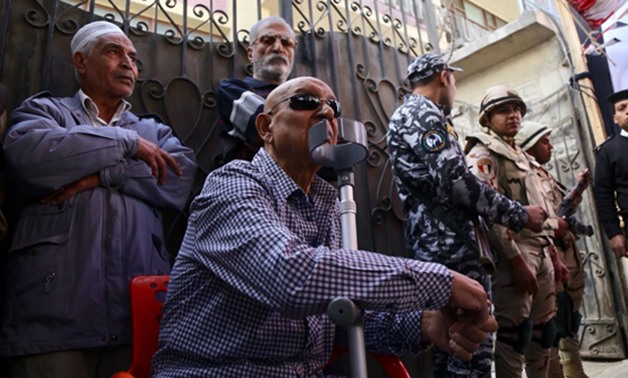 An elderly man sitting on a wheelchair outside a polling station to cast his vote in the presidential election on Monday in headquarters of The Workers University - Egypt Today- Mohamed al-Hosary
