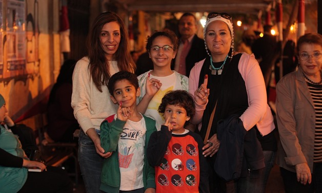 A family at Qasr al-Dubara School in downtown at night after the adults voted on March 26, 2018 - Ahmed Hindy