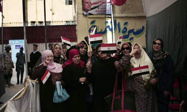Women pose for a photograph after voting during the first day of the presidential election outside a polling site in Cairo, Egypt, Monday, March 26, 2018. (AP Photo/Nariman El-Mofty)